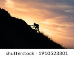 Young man climbing up to top of mountain. Self improvement and motivational goals concept. 