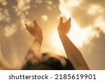 Woman's hands reaching up to the sunlight sunny sky. Feelings of hope, worship concept. 