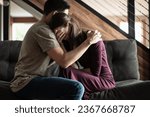Small photo of Husband comforting grieving sad wife. Helping a friend giving a shoulder to cry on, family problems, people giving mental support.