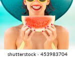 Fun beach summer holiday concept.  Woman holding watermelon on the beach. 