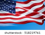 american flag under blue sky. | Shutterstock . vector #518219761