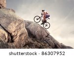 Cyclist climbing on a rock