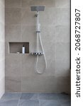 Small photo of Shower at bathroom. ฺBathroom interior with shower stall and soap Gel bottle. Luxury fully tiled shower with rain head and hand held shower rose.