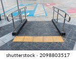 Concrete ramp way with stainless steel handrail  for support wheelchair disabled people. Ramp way to support wheelchair disabled people.