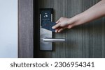 Small photo of Smart card door key lock system in hotel. Hotel electronic lock on wooden door. Entrance door with electronic card lock security. Digital door lock security systems for access protection of hotel