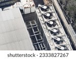 Small photo of Cooling towers in data center building. Air conditioning cooling towers in front of building with fins to the front. Industrial cooling towers or air cooled water chillers with piping system.