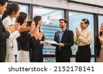 Small photo of Employee gets a certificate of achievement, Businesspeople with certificate in the office, Businessman giving appreciation certificate to employee for achievement