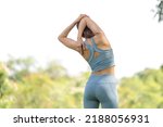 Small photo of Back view of sport woman warming up outdoors, Fitness woman doing stretch exercise stretching her arms