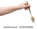 isolated of a woman's hand holding a golden fork to pick food.