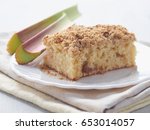 Small photo of Piece of coffeecake isolated on white. Biscuit with strawberry, rhubarb and apples. Homemade crumble pie with streusel topping. Selective focus.