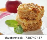 Small photo of Two pieces of coffeecake on white plate. Fresh crumble pie with streusel topping. Selective focus.