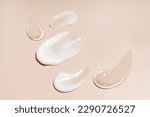 Small photo of Soothe cream lotion moisturiser gel smears on beige background. Skincare and body beauty product. Liquid gel cosmetic smudges