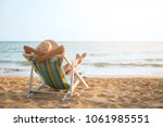 Summer beach vacation concept, Asia woman with hat relaxing and arm up on chair beach at Koh Mak, Trad, Thailand