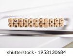 Small photo of Word impropriety by wooden cubes