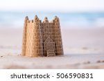 Small photo of A Childs sand castle waiting for the ocean tide to come in to reclaim it