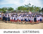 Small photo of Prachinburi, Thailand, Dec 7, 2018 -Group of primary students in scouting uniform singing Auld Lang Syne song in closing ceremony