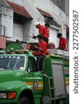 Small photo of Davao City, Philippines - March 18, 2023: Firetruck with fire fighters on board, 86th Araw ng Dabaw Celebration