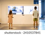 Small photo of Children learn interactively by looking at monitors and performing certain movements, visiting a science museum