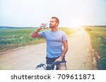 handsome man riding bike and drinking water resting