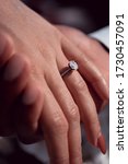 Small photo of Beautifully manicured hand wearing an oval solitaire diamond engagement ring