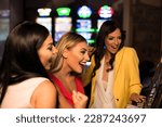 Beautiful and Well Dressed Girls Playing Automat Machine in the Casino and Celebrate