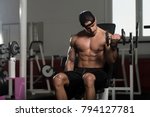 Man Working Out Biceps In A Gym ...