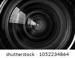 Photo Camera or Video lens close-up on black background, objective, concept of photographer camera man job, looking for a photographer, journalist, a videographer to work black and white