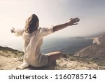 woman taking a breath in front of a spetacular view