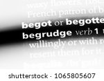 Small photo of begrudge word in a dictionary. begrudge concept.