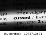 Small photo of cussed word in a dictionary. cussed concept