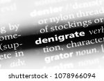 Small photo of denigrate word in a dictionary. denigrate concept