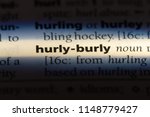 Small photo of hurly burly word in a dictionary. hurly burly concept.