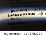 Small photo of inauspicious word in a dictionary. inauspicious concept.
