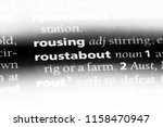 Small photo of roustabout word in a dictionary. roustabout concept.