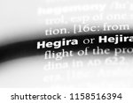Small photo of hegira word in a dictionary. hegira concept.
