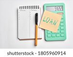 Small photo of calculater ,pen and blank notebook for office on white background isolated. loan sign