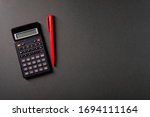 Calculator And Red Pen  On A...