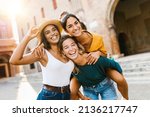 Multiethnic group of three happy young women having fun on summer vacation - Diverse female friends laughing together during their holidays - United people concept - Focus on african woman face