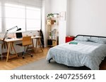 Small photo of Cozy interior teenager room with bed and desk workplace. Young content creator teenager bedchamber.