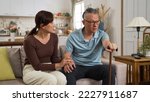 Small photo of Asian Japanese adult daughter looking at confused grandfather with hand on chest and feeling surprised as he can’t recall who she is at home. memory loss in Alzheimer’s disease concept