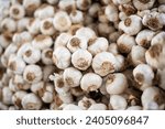 Small photo of White garlic pile texture. Fresh garlic on market table closeup photo. Vitamin healthy food spice image. Spicy cooking ingredient picture. Pile of white garlic heads. White garlic head heap top view