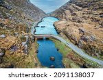 Small photo of Aerial view of the stone Wishing Bridge over winding stream in green valley at Gap of Dunloe in Black Valley of Ring of Kerry, County Kerry, Ireland