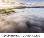 Aerial view from drone of sea of clouds in the morning over the mountains hills and farmland at Khao Kho, Phetchabun, Thailand.
Foggy and cloud inversion over the mountains.