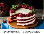Red velvet cake on wood board. Slice of cake. Raspberry cake. Devil's cake. Wedding dessert. Birthday party. Delicious dessert. Traditional american dessert