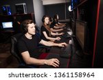 Small photo of Casual gamers and hardcore fans are gather together in pc gaming club to compete in playing MMO Games online Tournament