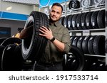 Small photo of customer tire fitting in the car service, auto mechanic checks the tire and rubber tread for safety, concept: repair of machines, fault diagnosis, repair. man buy in car service shop