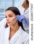 Small photo of Side view close-up photo of young beautiful woman came to beautician to get PDO thread, Thread Lifting procedure. Aesthetic beauty anti aging, face lifting surgery. Chossing the best thread