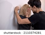 Small photo of male attacks woman, domestic violence. Drunk husband beats wife. An aggressive man hits young wife, female, crying. Pinned to the wall and scared. family domestic domination couple