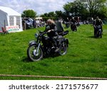Small photo of 29th May 2022- A classic AJS Model 18 motorcycle being ridden at a vintage show near Newcastle Emlyn, Ceredigion, Wales,.