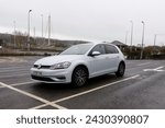 Small photo of 20th February 2024- A stylish Volkswagen Golf SE Bluemotion Tdi, five door hatchback car, parked in a public carpark at Carmarthen, Carmarthenshire, Wales, UK.